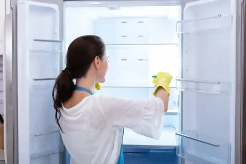 woman-cleaning-refrigerator-interior